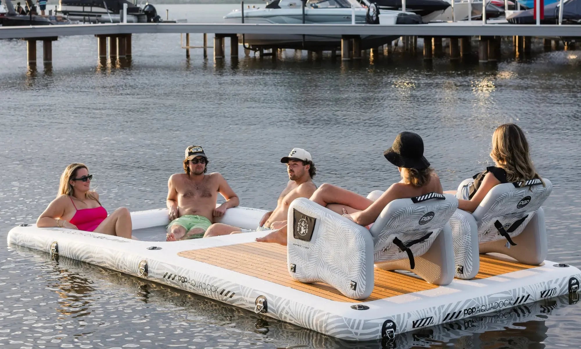 Inflatable popup aquadock with floating lounge chairs for water sports