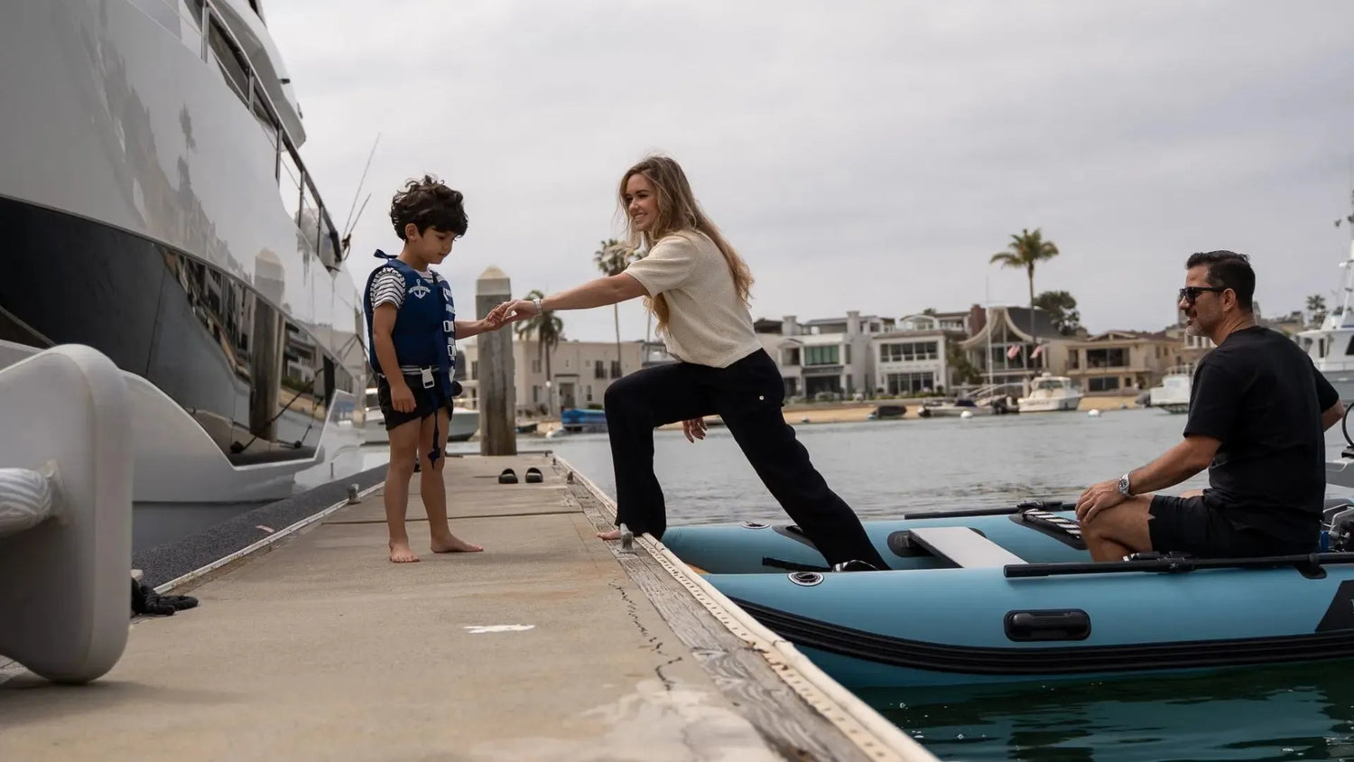 Rover Marine inflatable dinghy family boarding at dock